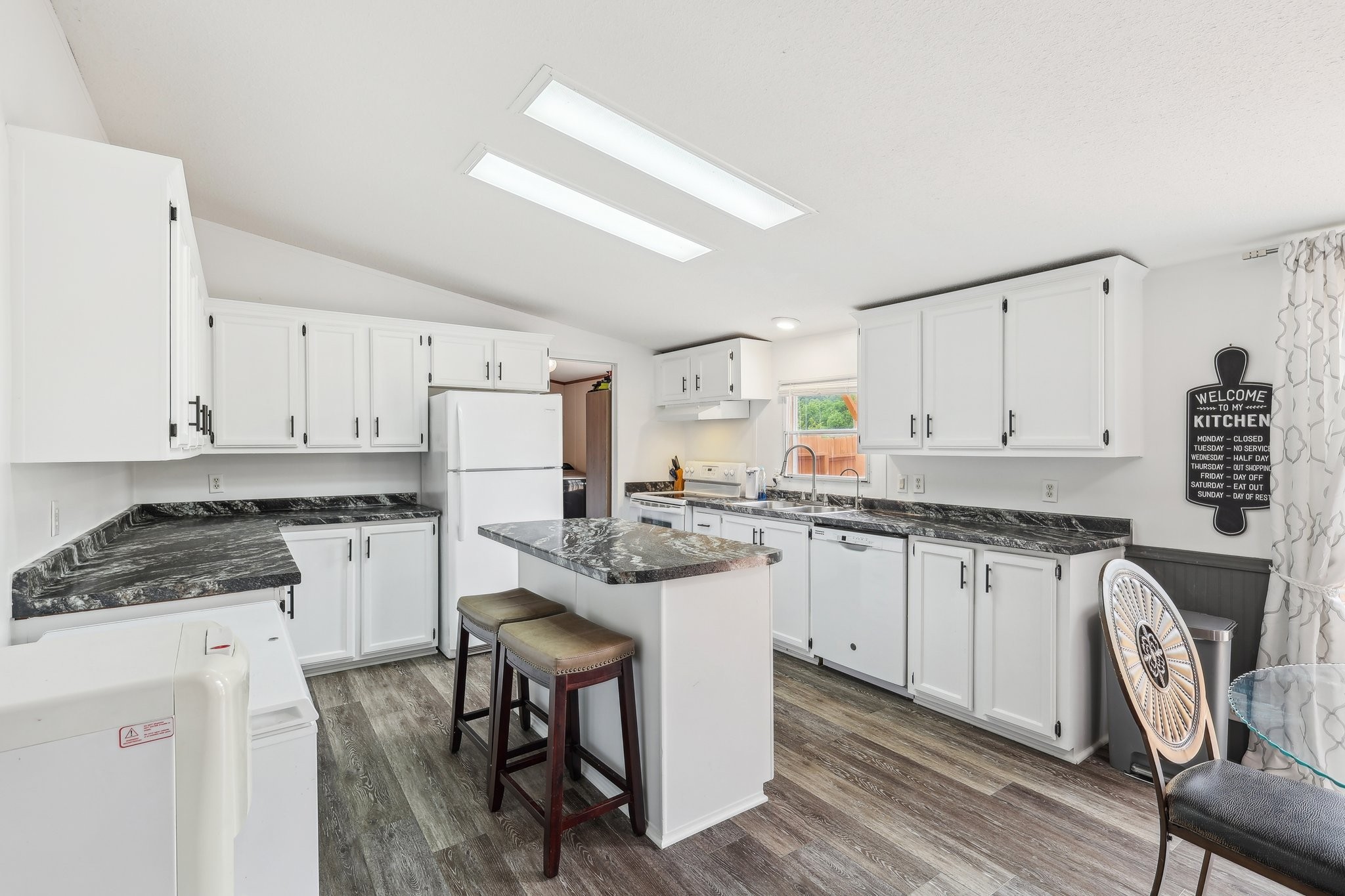 12056 Newtown Road Rockvale, TN 37153 - Photo 19 of 65 a kitchen with granite countertop white cabinets and white appliances