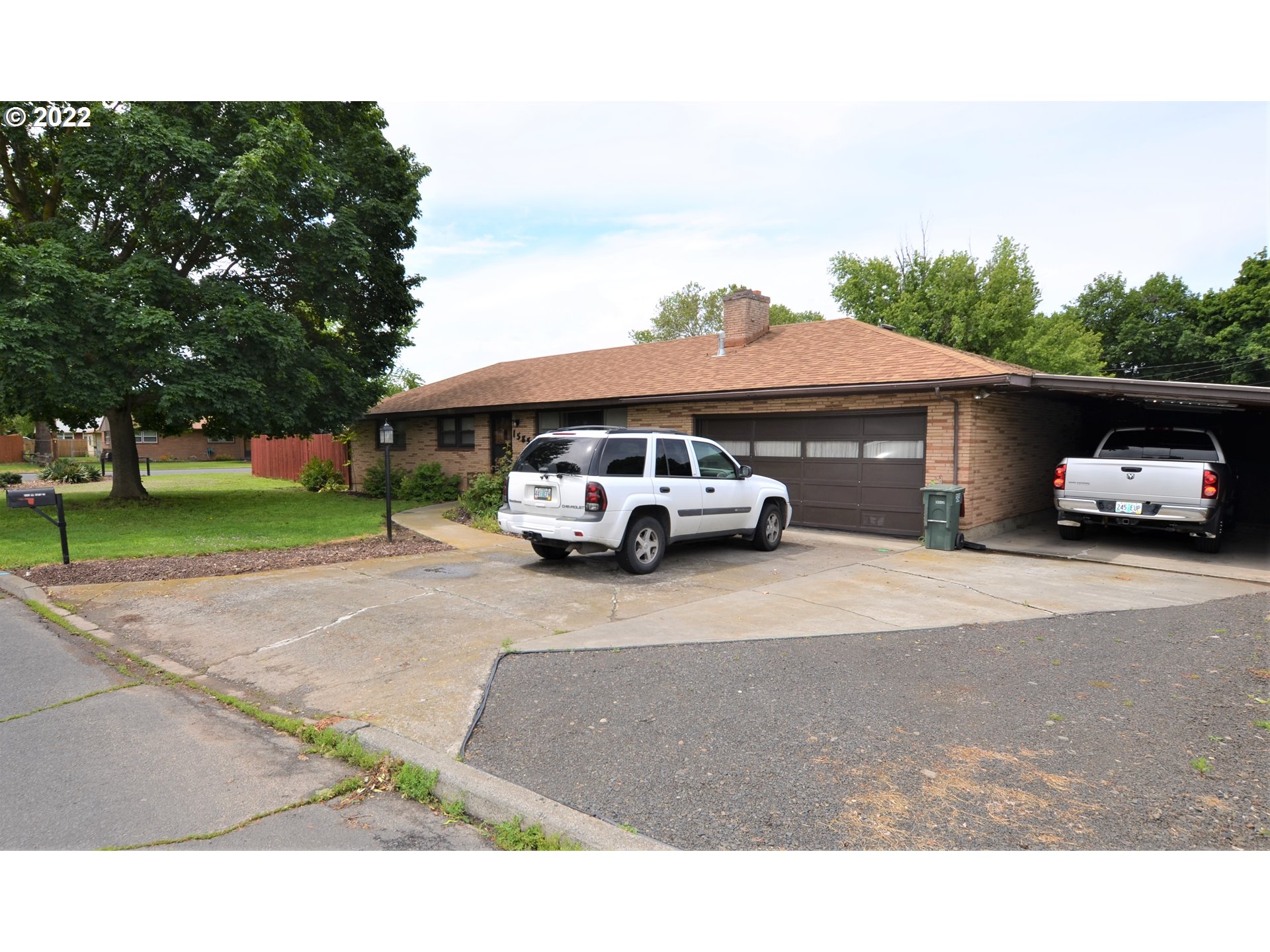 1585 Southwest 40th Street Pendleton, OR 97801 - Photo 1 of 20 a car parked in front of a house with a yard