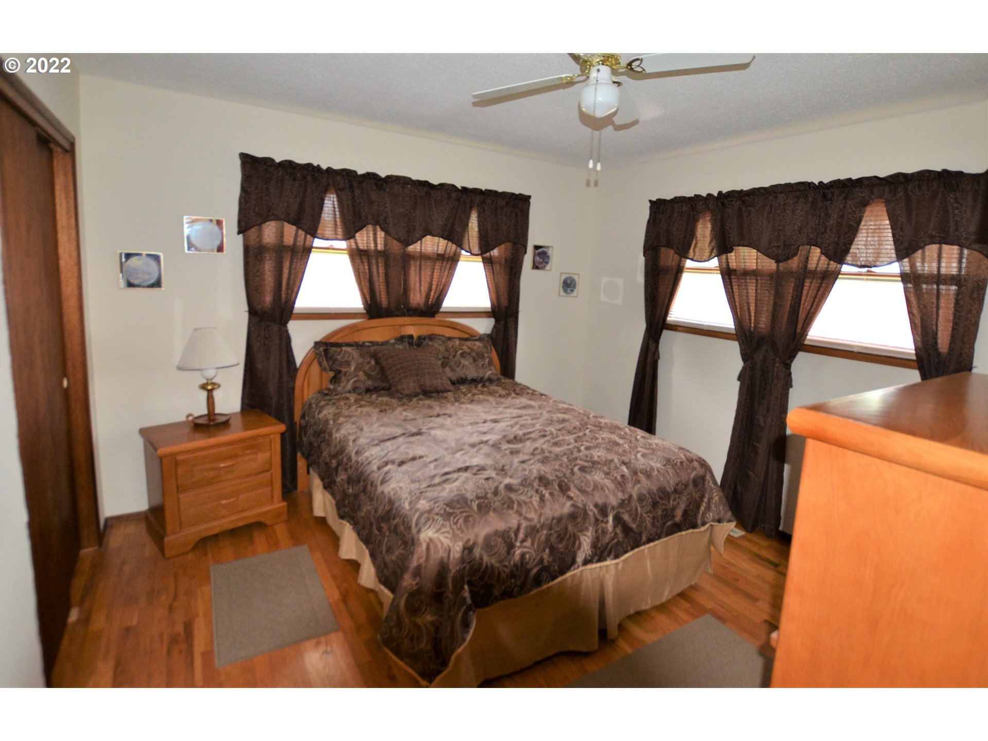 1585 Southwest 40th Street Pendleton, OR 97801 - Photo 11 of 20 a bedroom with a bed and wooden floor