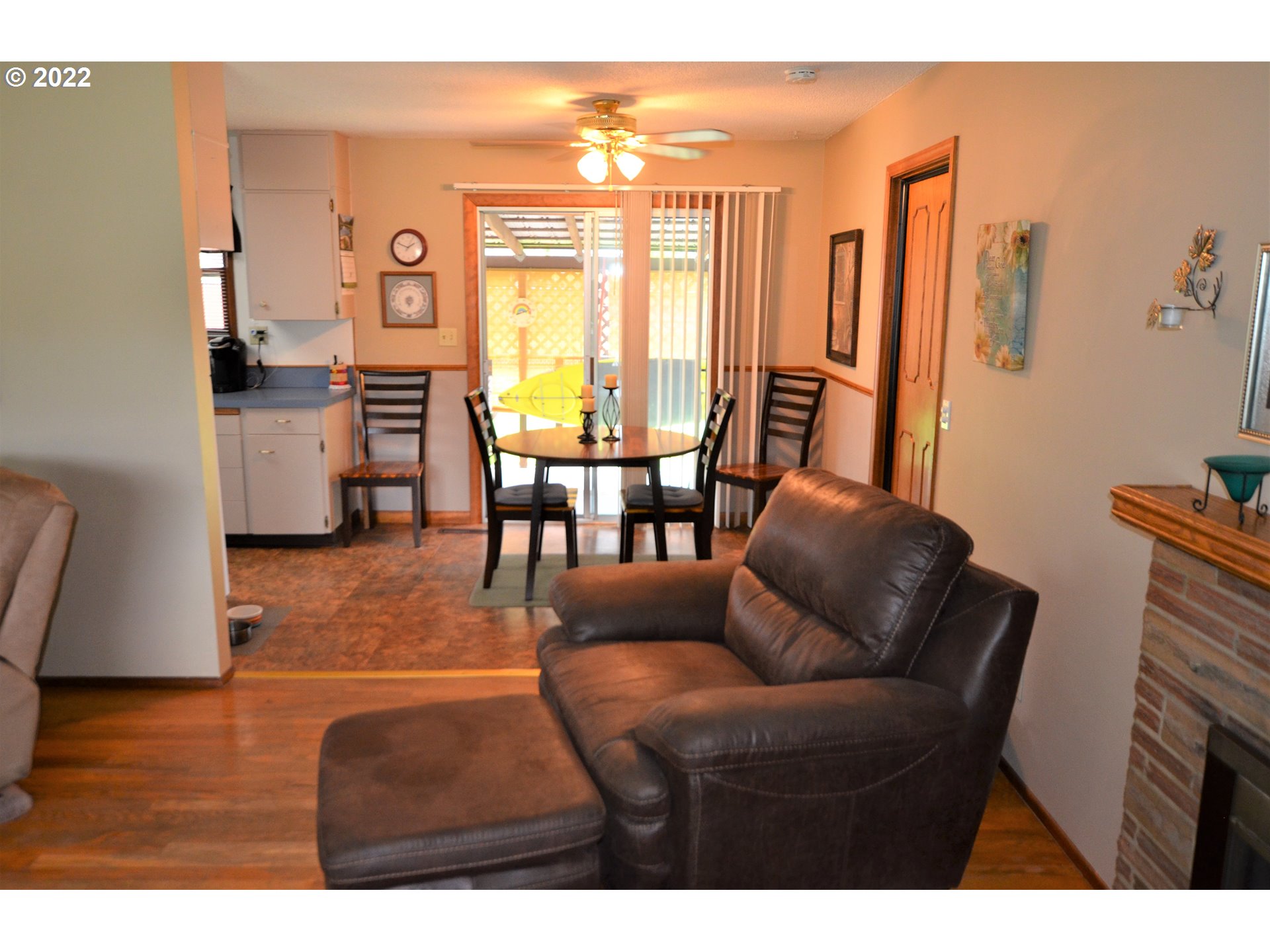 1585 Southwest 40th Street Pendleton, OR 97801 - Photo 6 of 20 a living room with furniture and a dining table with floor to ceiling window
