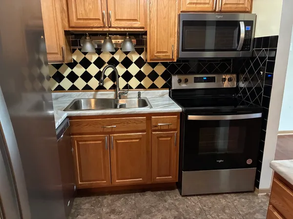 a kitchen with a sink a stove and microwave