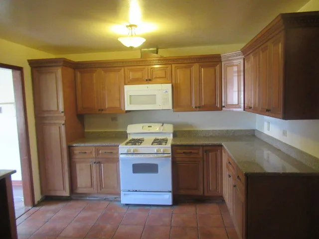 a kitchen with a stove a sink and a refrigerator