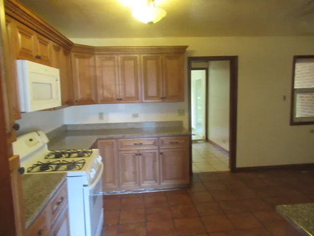 a kitchen with a stove a sink and a cabinets