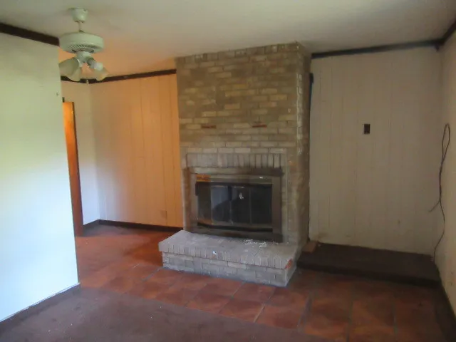 a view of empty room with a fireplace