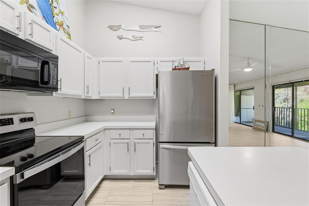 32 Navarra Court St. Augustine, FL 32086 - Photo 18 of 51 a kitchen with a refrigerator and a stove top oven