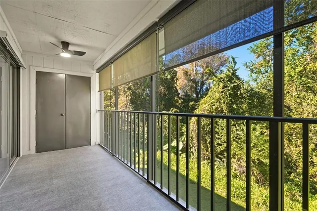an empty room with floor to ceiling window and an outdoor view