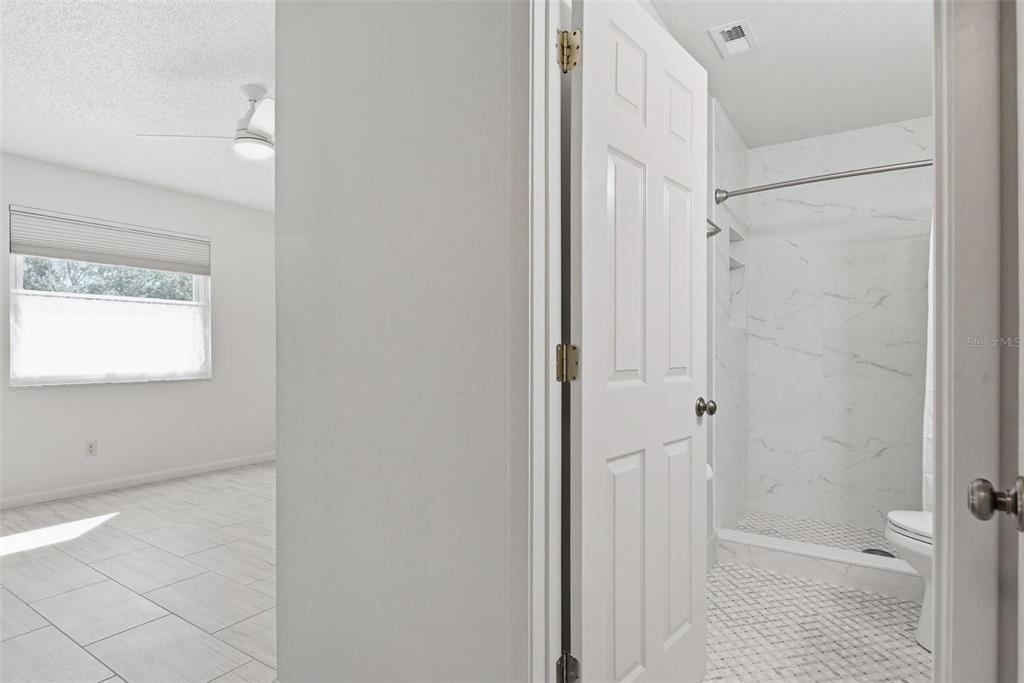 32 Navarra Court St. Augustine, FL 32086 - Photo 26 of 51 a bathroom with a granite countertop sink a toilet and shower