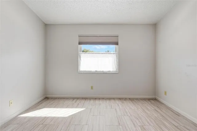 an empty room with wooden floor
