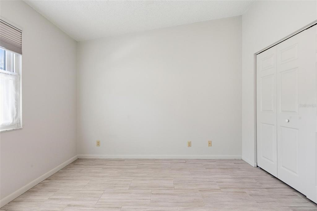 32 Navarra Court St. Augustine, FL 32086 - Photo 31 of 51 a view of an empty room with wooden floor and a window