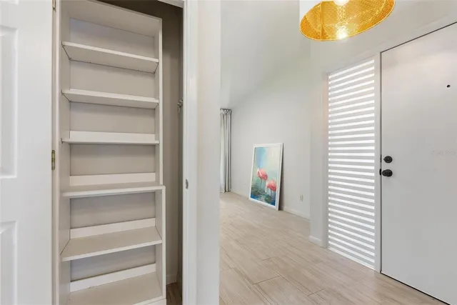 a view of a house with backyard and a tree