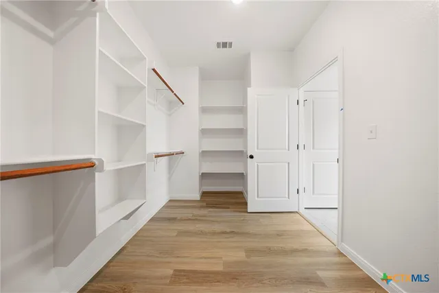 a bathroom with a double vanity sink a mirror a bathtub and shower