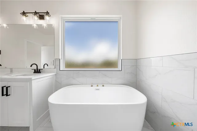 an empty room with a bathroom and a shower