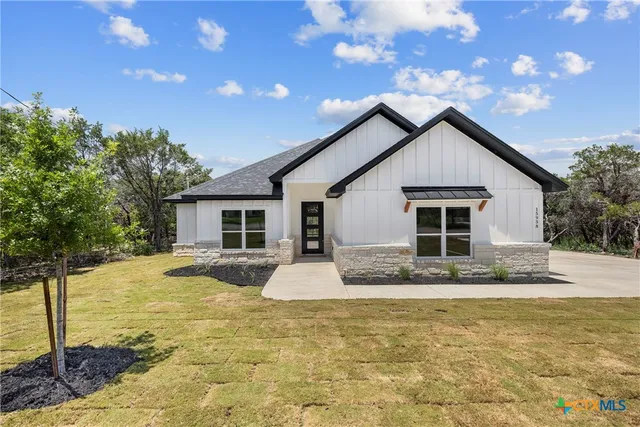 a view of a hallway with wooden floor and a window