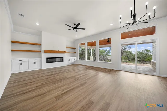 a view of empty room with a fireplace and window