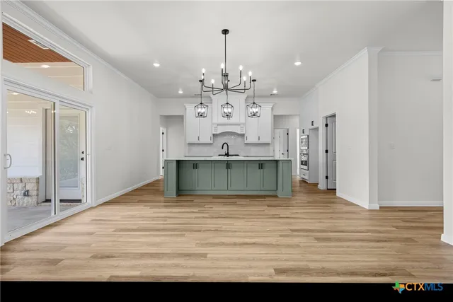 a view of kitchen and kitchen with furniture wooden floor and window