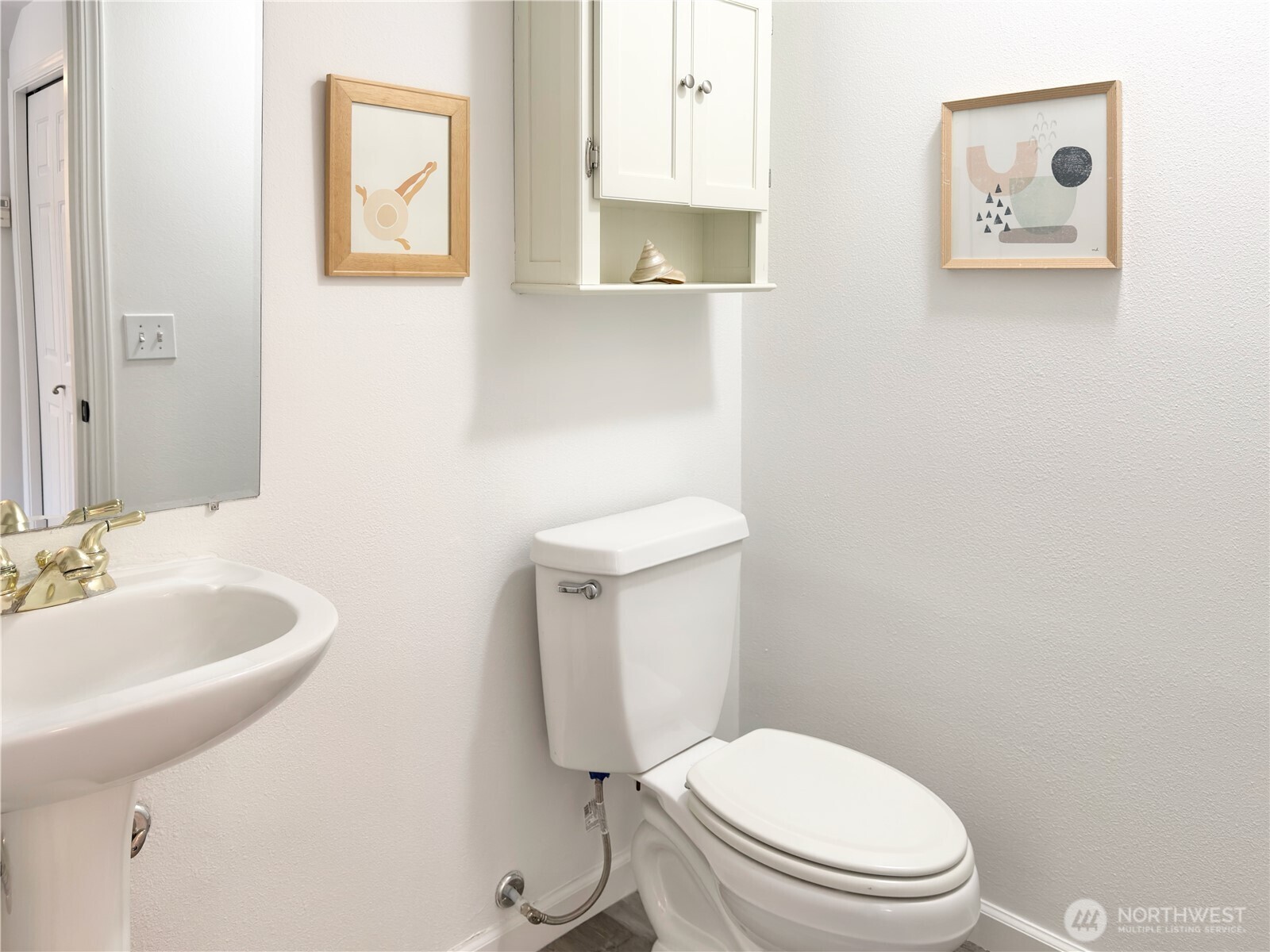 210 10th Street, Unit 4 Kirkland, WA 98033 - Photo 13 of 35 a white toilet sitting next to a bathroom sink
