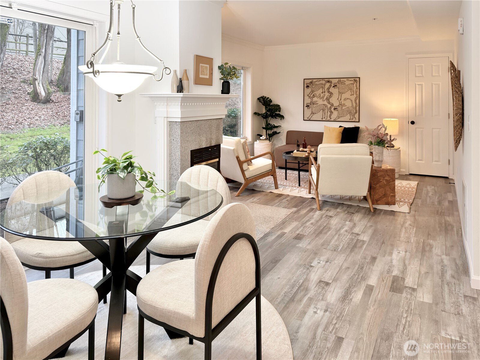 210 10th Street, Unit 4 Kirkland, WA 98033 - Photo 4 of 35 a living room with furniture a table and a chandelier