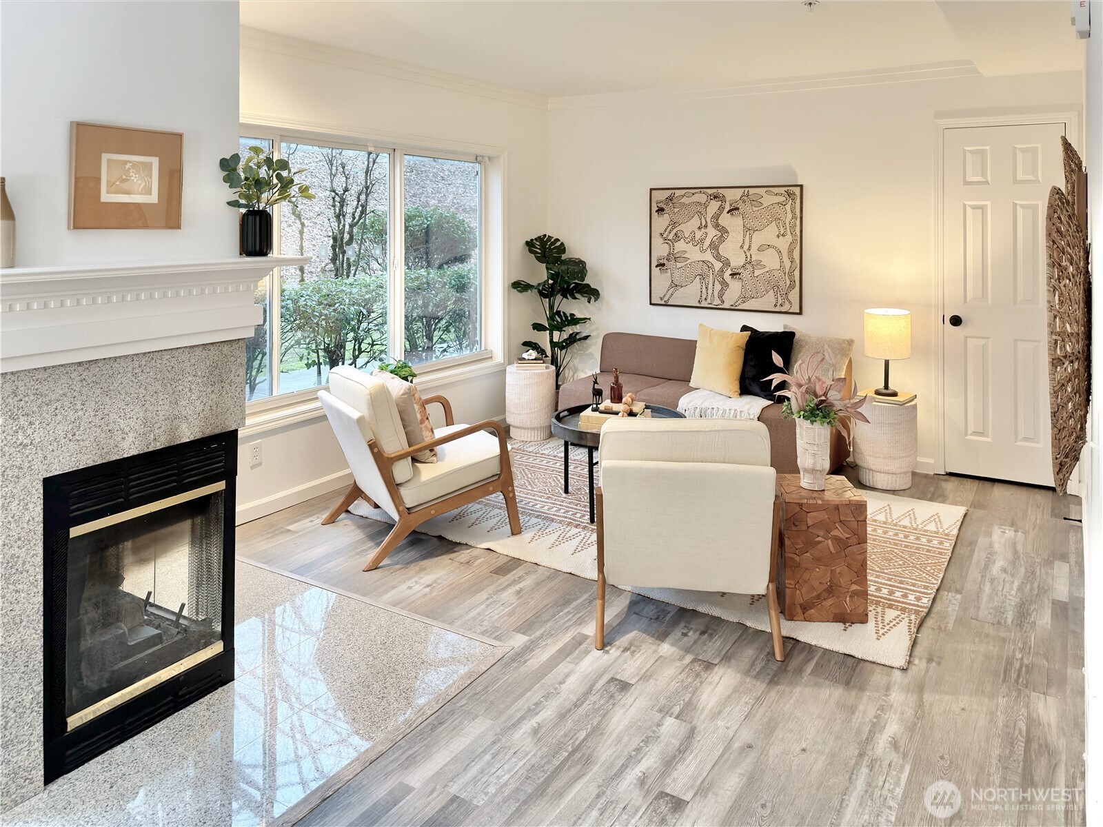 210 10th Street, Unit 4 Kirkland, WA 98033 - Photo 5 of 35 a living room with furniture a fireplace and a floor to ceiling window