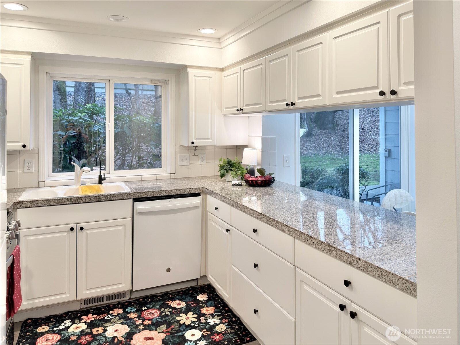 210 10th Street, Unit 4 Kirkland, WA 98033 - Photo 8 of 35 a kitchen with granite countertop white cabinets and white appliances