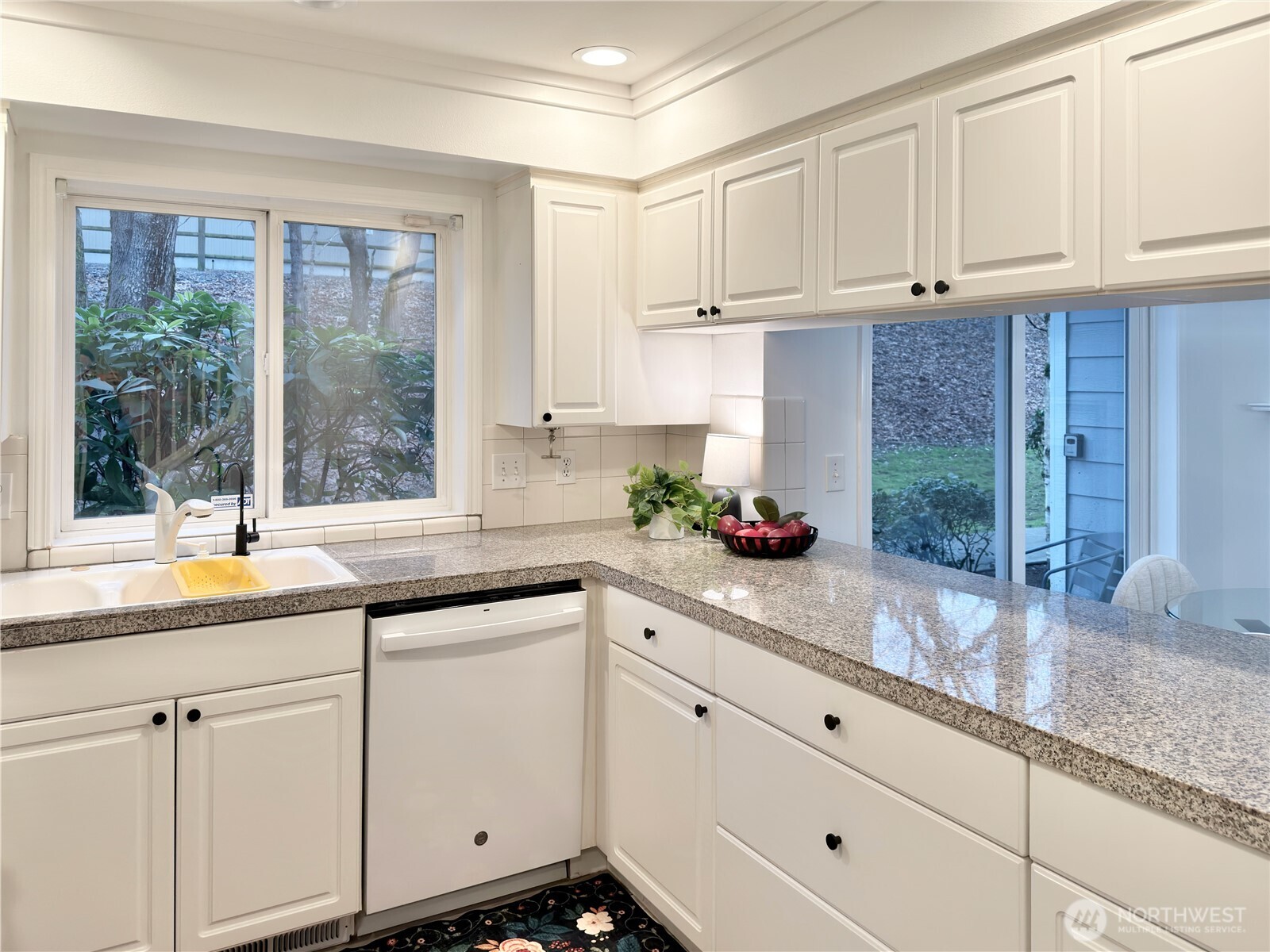 210 10th Street, Unit 4 Kirkland, WA 98033 - Photo 10 of 35 a kitchen with granite countertop stainless steel appliances white cabinets and a window