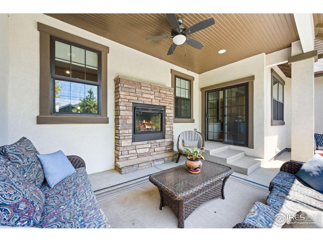 1442 Prairie Hawk Road Eaton, CO 80615 - Photo 32 of 40 Covered Back Patio with Gas Fireplace & Ceiling Fan. Entertaining at it's finest!