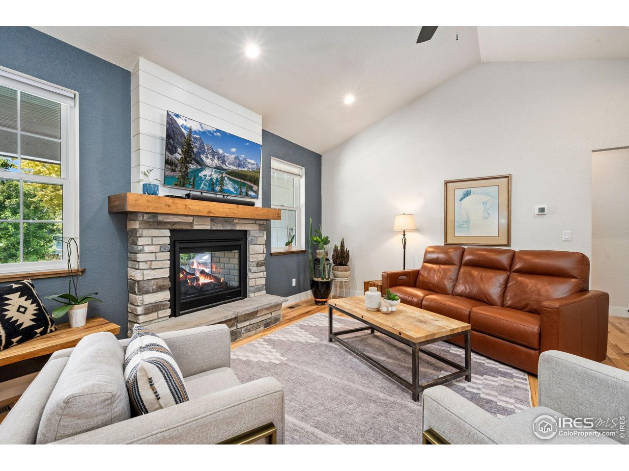 1442 Prairie Hawk Road Eaton, CO 80615 - Photo 5 of 40 Dual-Sided Gas Fireplace with Stone Surround & Vaulted Ceilings