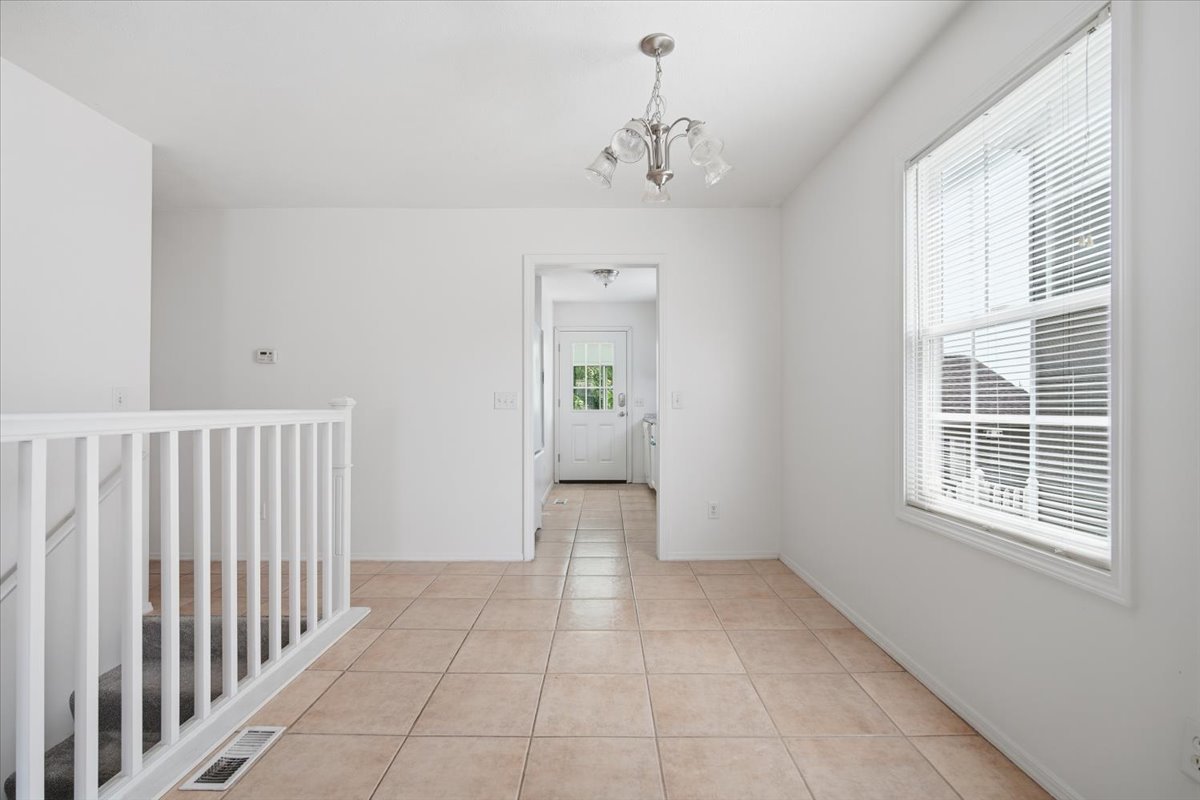 915 Teegan Street Normal, IL 61761 - Photo 6 of 33 a view of a hallway with wooden floor and a window