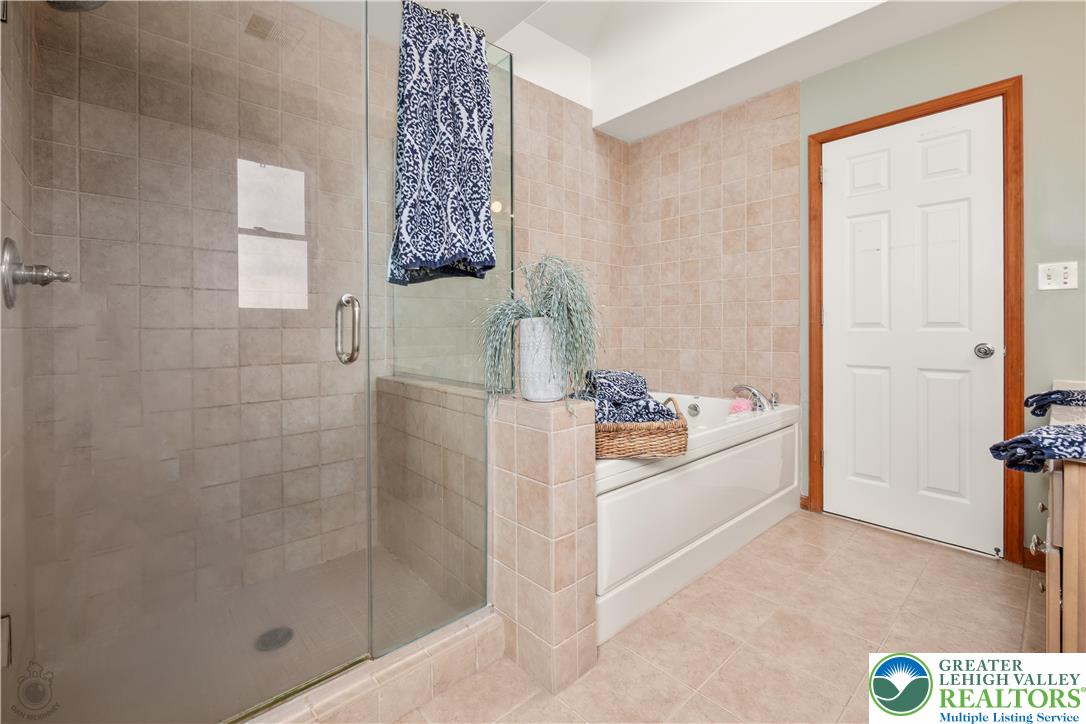 5 Farmstead Way Mount Bethel, PA 18343 - Photo 24 of 37 a bathroom with a bathtub and a shower