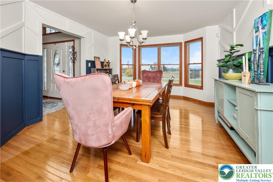 5 Farmstead Way Mount Bethel, PA 18343 - Photo 6 of 37 a dining room with furniture a chandelier and wooden floor