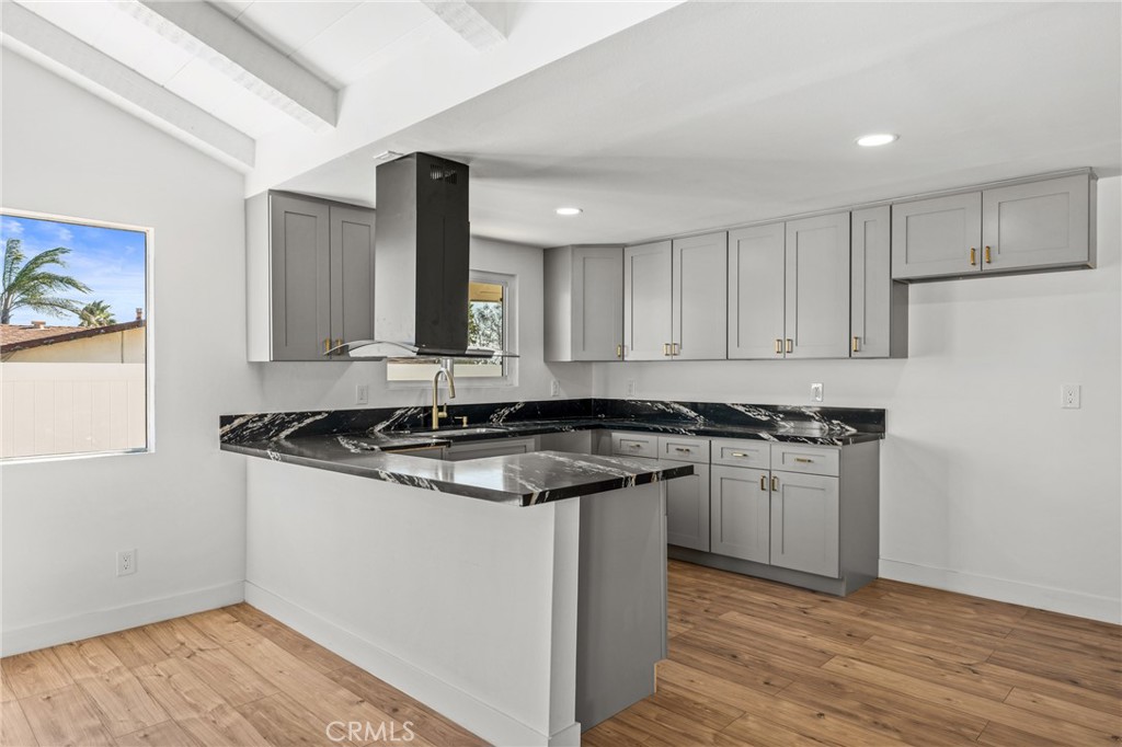 1423 Terrace Road Rialto, CA 92376 - Photo 16 of 40 a kitchen with stainless steel appliances granite countertop a stove and a sink