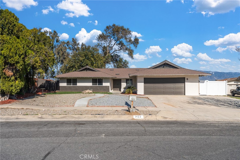 1423 Terrace Road Rialto, CA 92376 - Photo 2 of 40 a front view of a house with a yard and garage