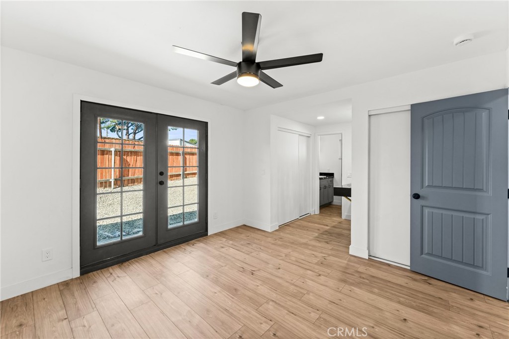 1423 Terrace Road Rialto, CA 92376 - Photo 22 of 40 a view of an empty room with wooden floor and a window