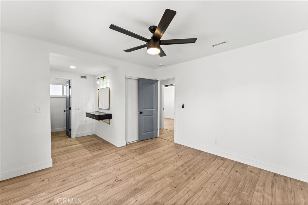 1423 Terrace Road Rialto, CA 92376 - Photo 23 of 40 a view of empty room with wooden floor and ceiling fan