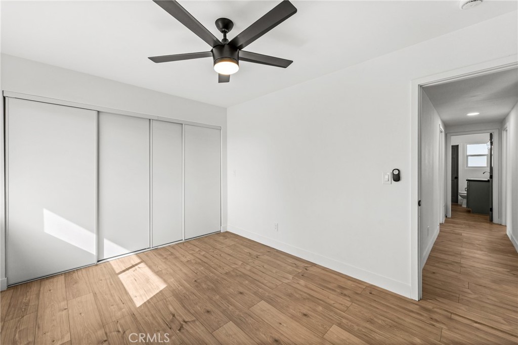 1423 Terrace Road Rialto, CA 92376 - Photo 32 of 40 an empty room with wooden floor and mirror