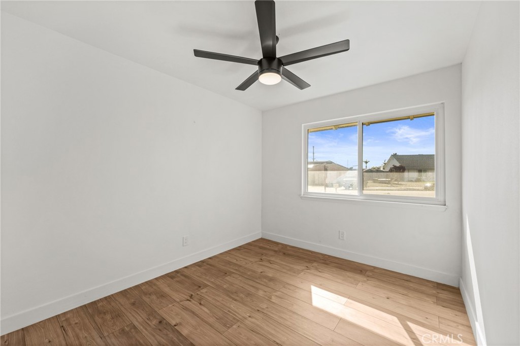 1423 Terrace Road Rialto, CA 92376 - Photo 34 of 40 a view of empty room with wooden floor and fan