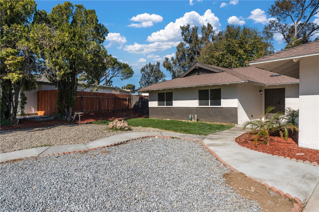 1423 Terrace Road Rialto, CA 92376 - Photo 4 of 40 a front view of a house with a yard and a garage