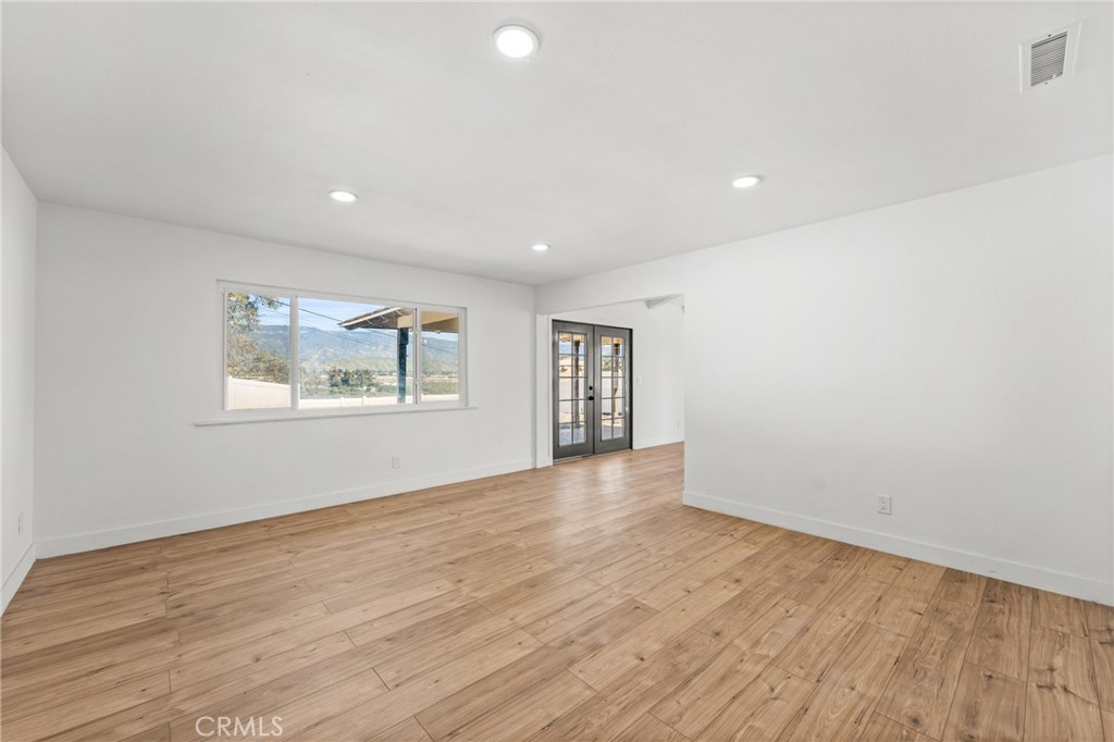 1423 Terrace Road Rialto, CA 92376 - Photo 7 of 40 wooden floor in an empty room with a window