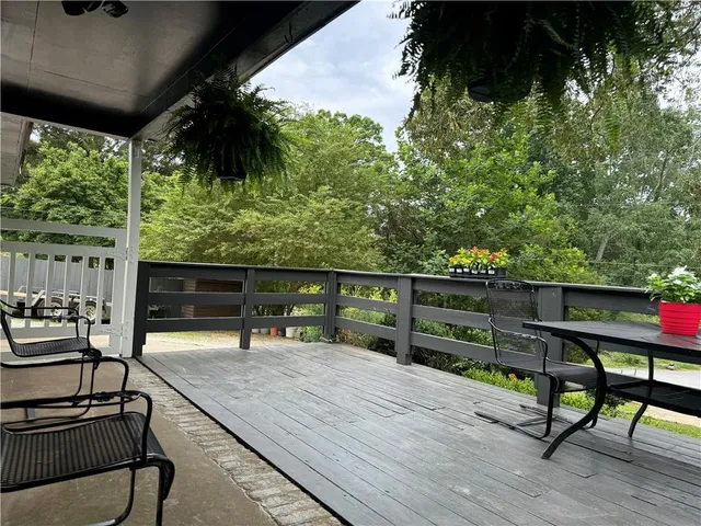 a view of a bench and chairs in patio