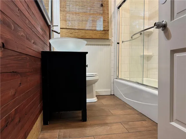 a bathroom with a toilet a sink and shower
