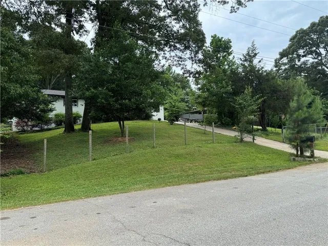 a view of a park with large trees