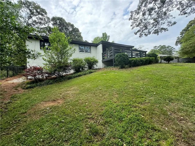 a view of a backyard with plants and a garden