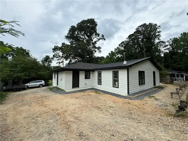 a view of a patio with table and chairs with wooden fence and plants