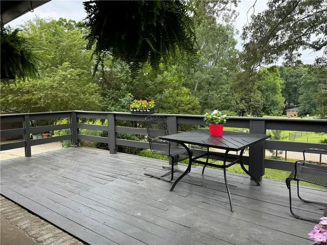 a view of a chairs and table in patio with wooden fence