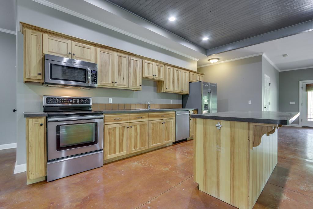 166 East Piney Road Dickson, TN 37055 - Photo 8 of 30 a kitchen with stainless steel appliances granite countertop a stove a sink and a microwave
