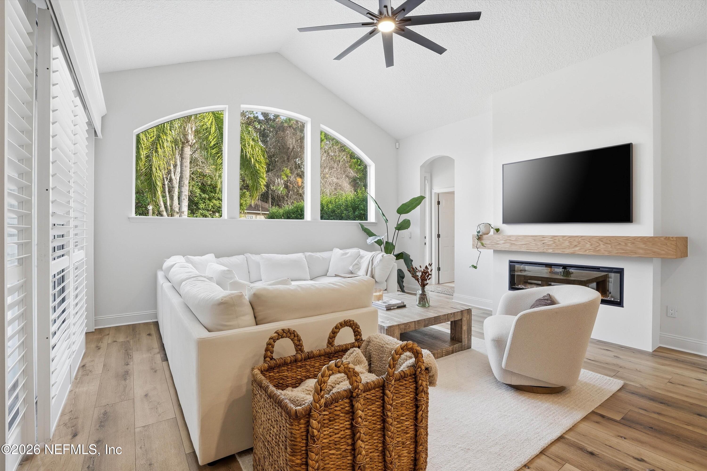 628 Pelham Road St. Augustine, FL 32092 - Photo 12 of 56 a living room with furniture a fireplace and a flat screen tv