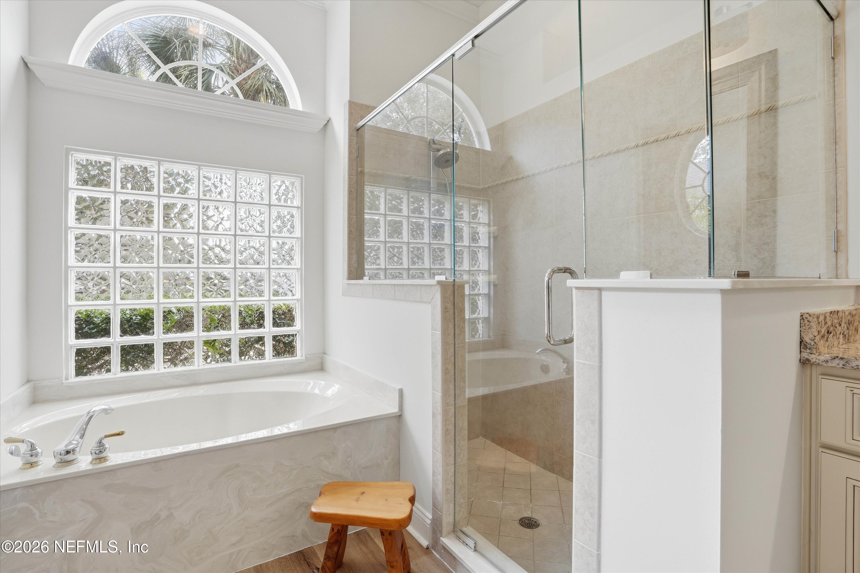 628 Pelham Road St. Augustine, FL 32092 - Photo 20 of 56 a bathroom with a bathtub and a shower