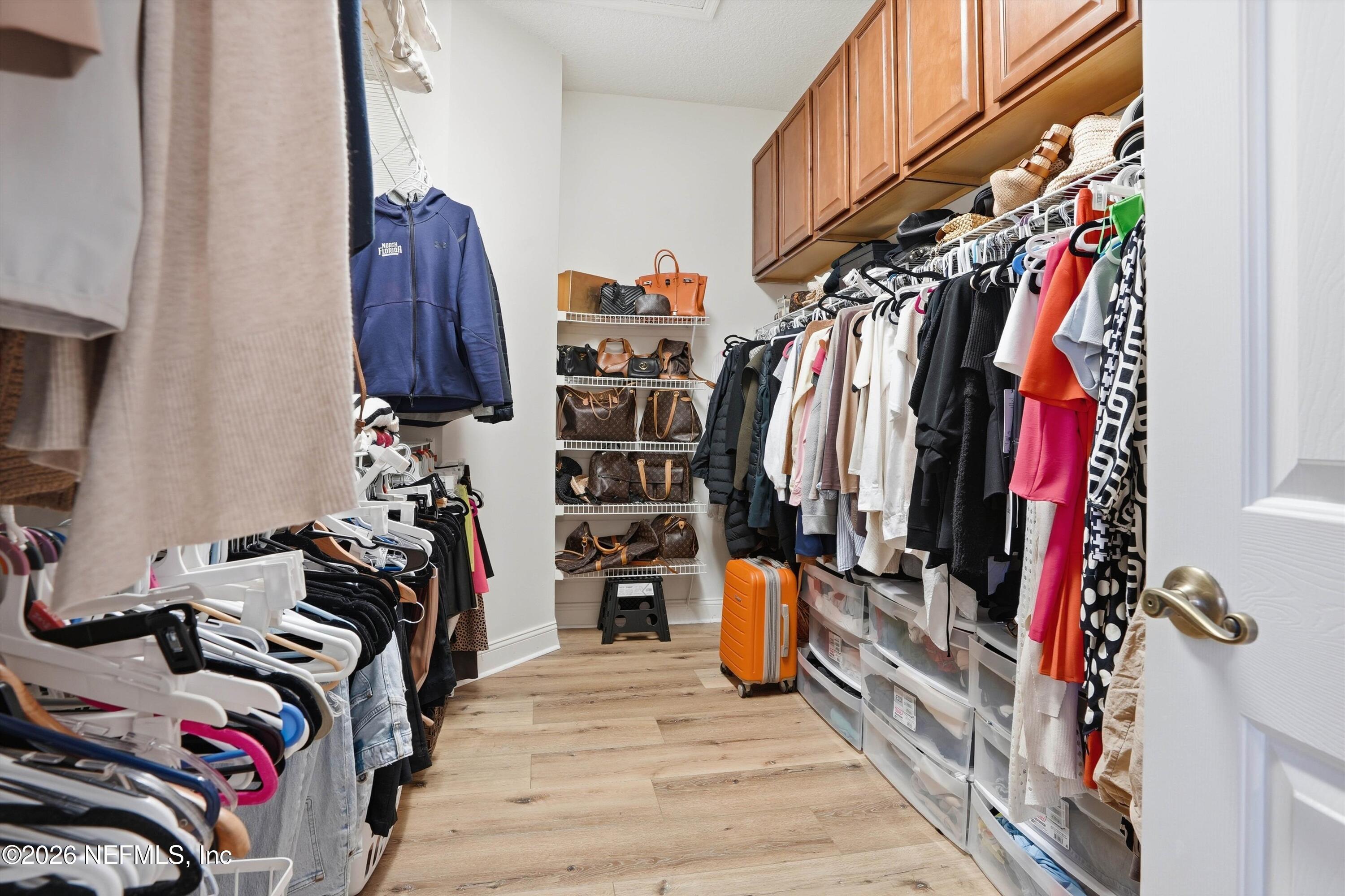 628 Pelham Road St. Augustine, FL 32092 - Photo 21 of 56 a view of walk in closet with clothes