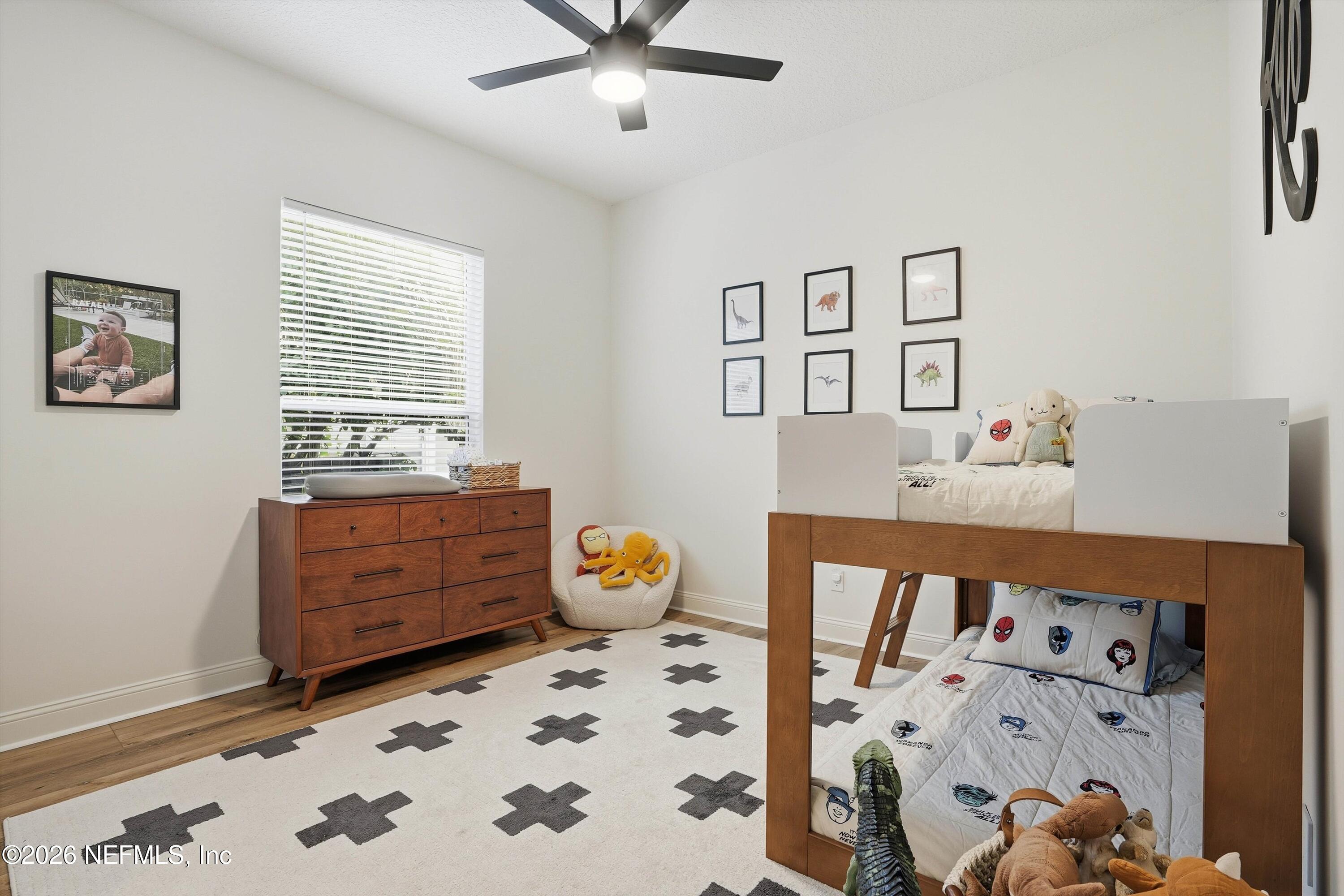 628 Pelham Road St. Augustine, FL 32092 - Photo 25 of 56 a bedroom with a bed and wooden floor