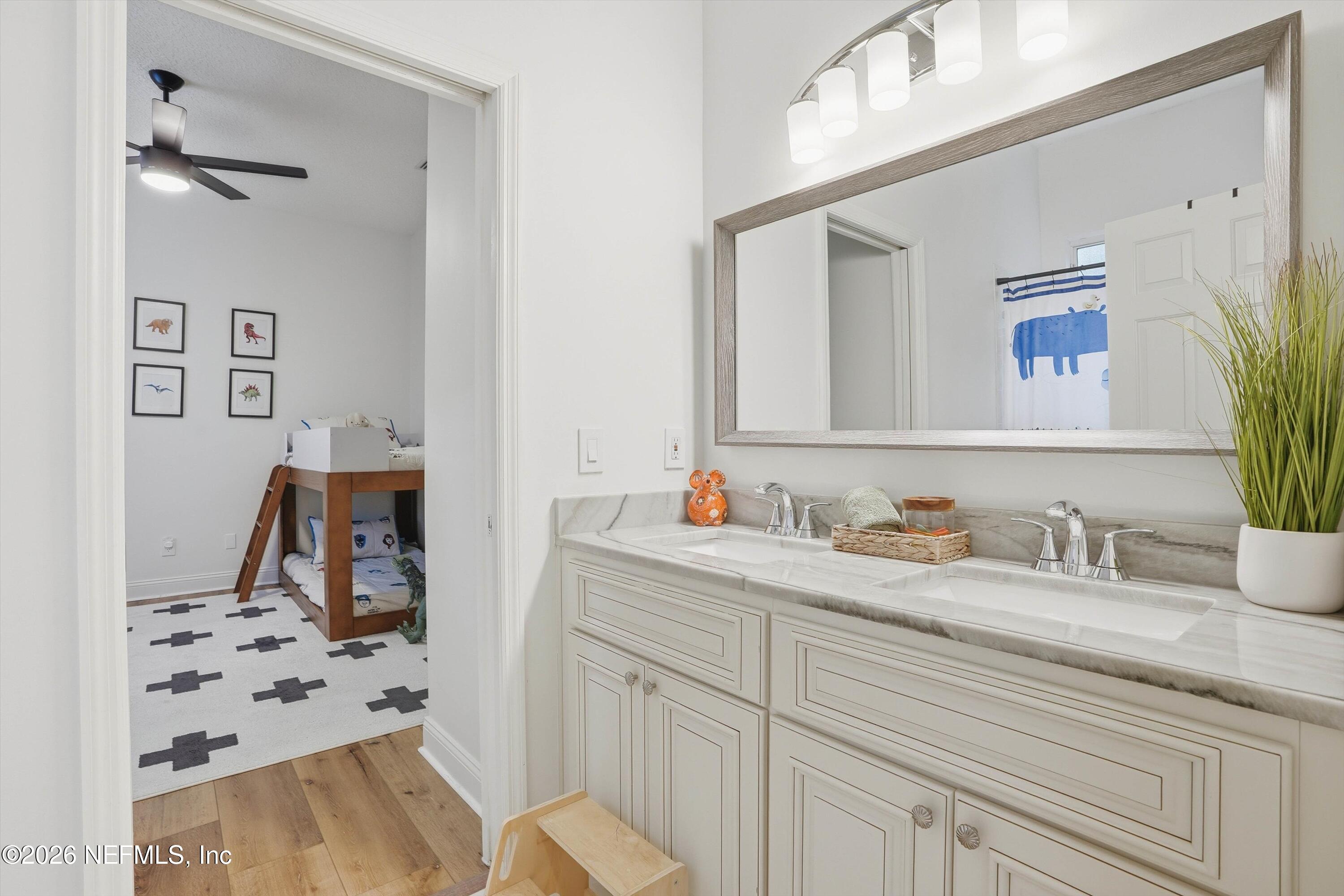 628 Pelham Road St. Augustine, FL 32092 - Photo 27 of 56 a bathroom with a sink and a mirror