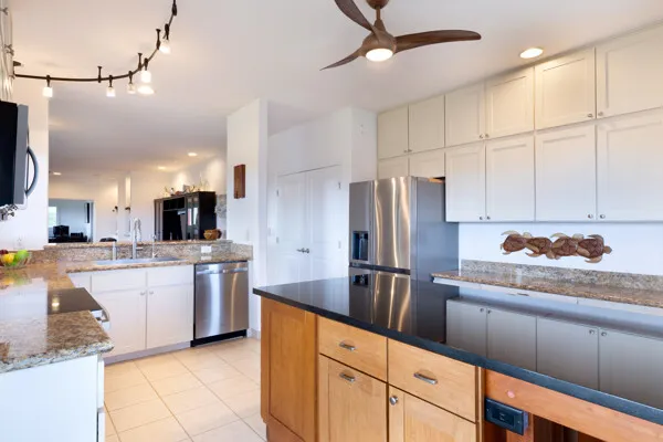 a kitchen with stainless steel appliances granite countertop a refrigerator and a sink